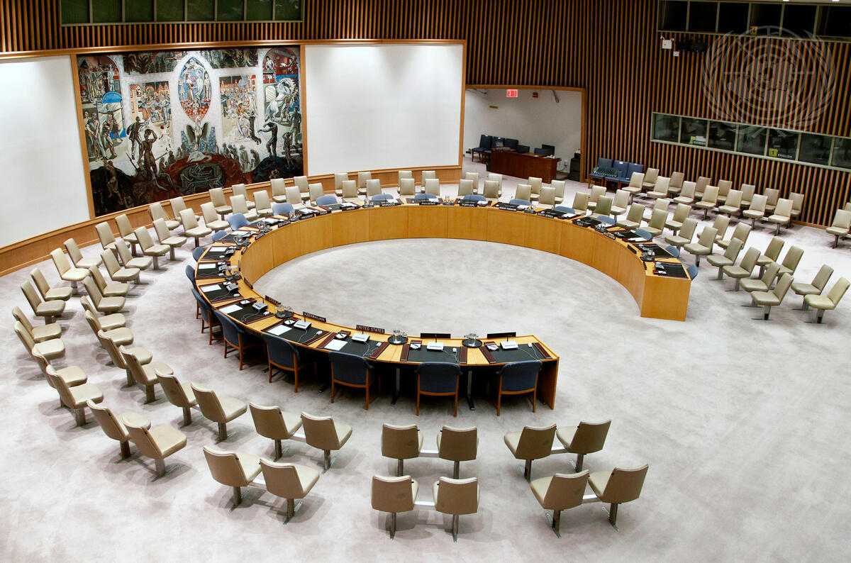 Photo of a conference room with a round table and chairs around it